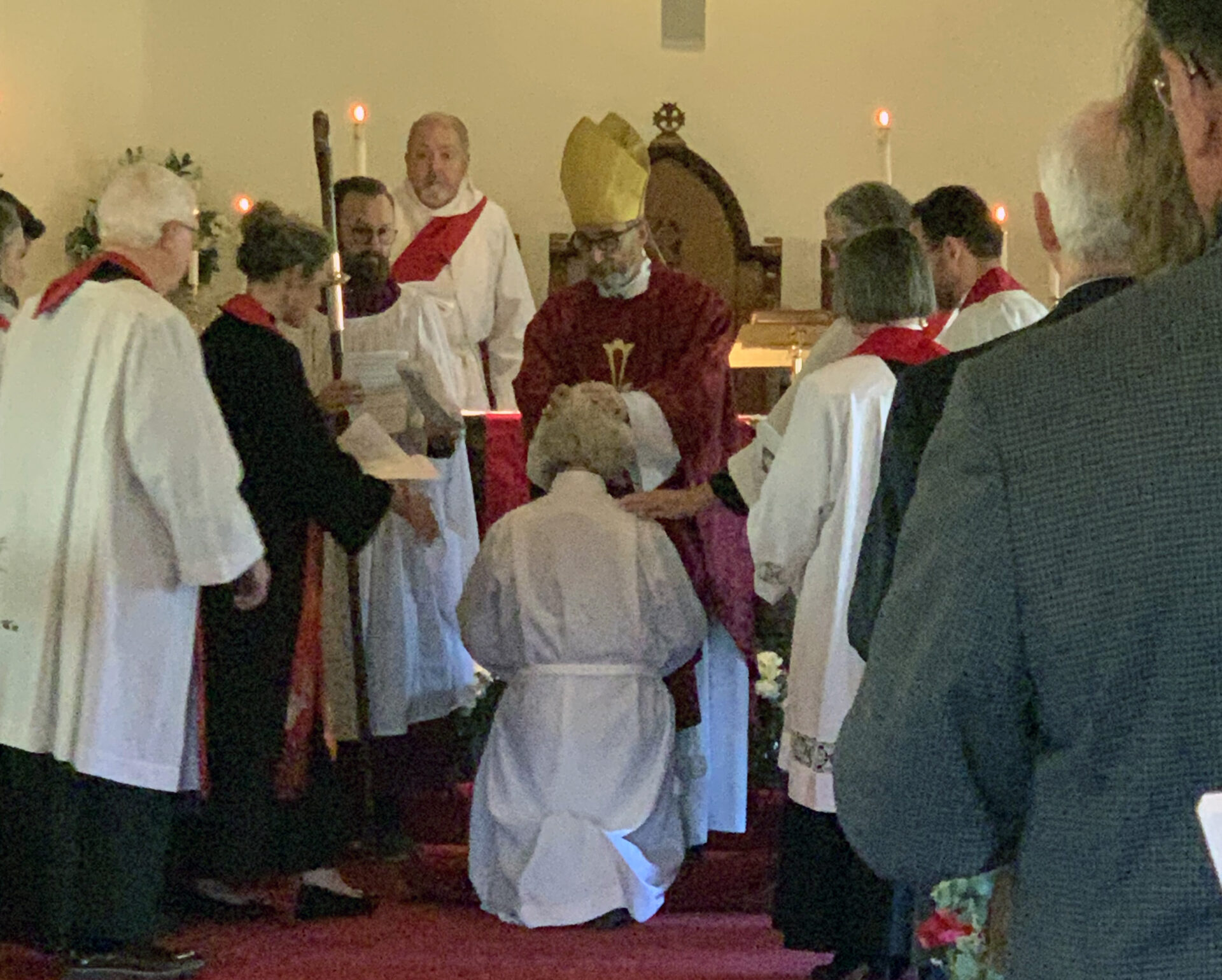 Karen Pettit kneels before Bishop Seage at ordination 2/11/2025